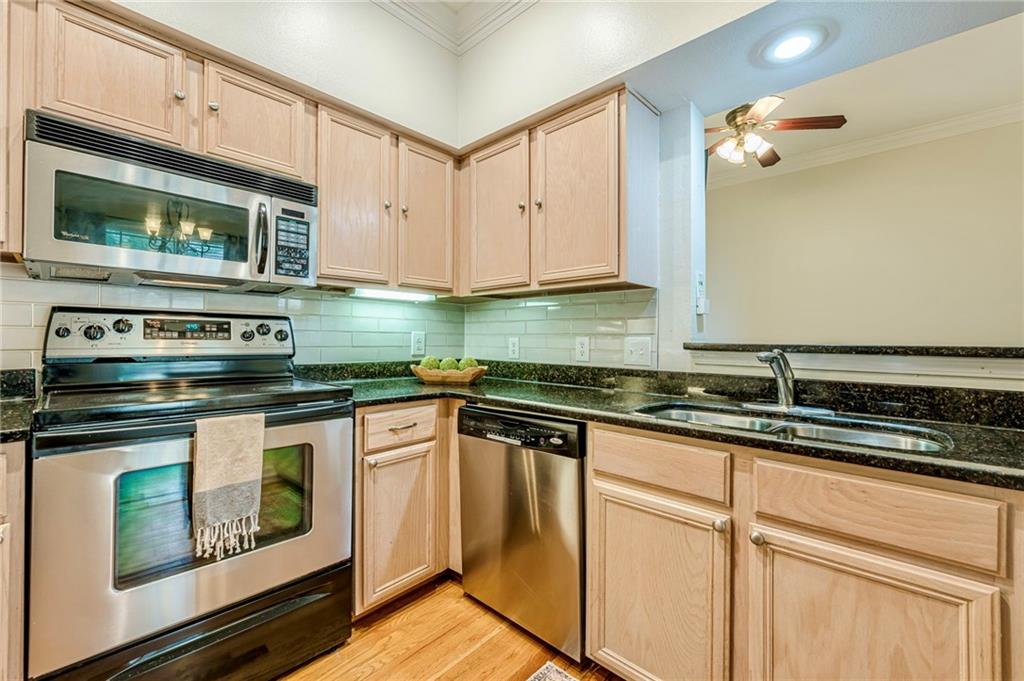 3777 Peachtree Road Northeast, Unit 1632 Brookhaven, GA 30319 - Photo 10 of 43 a kitchen with granite countertop white cabinets stainless steel appliances and a sink