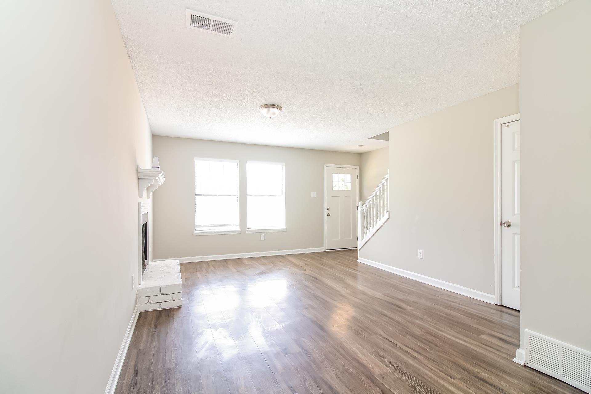 3546 Christine Road Memphis, TN 38118 - Photo 6 of 23 an empty room with wooden floor and windows