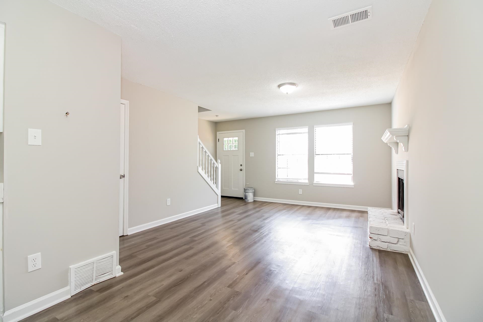 3546 Christine Road Memphis, TN 38118 - Photo 7 of 23 an empty room with wooden floor and windows