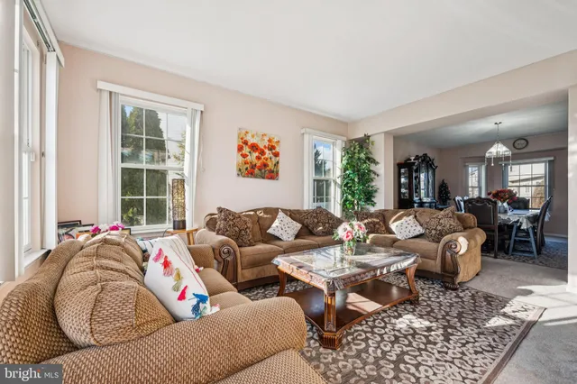 a living room with furniture fireplace and a window