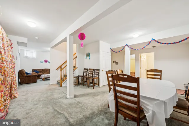 a livingroom with furniture and air hockey table
