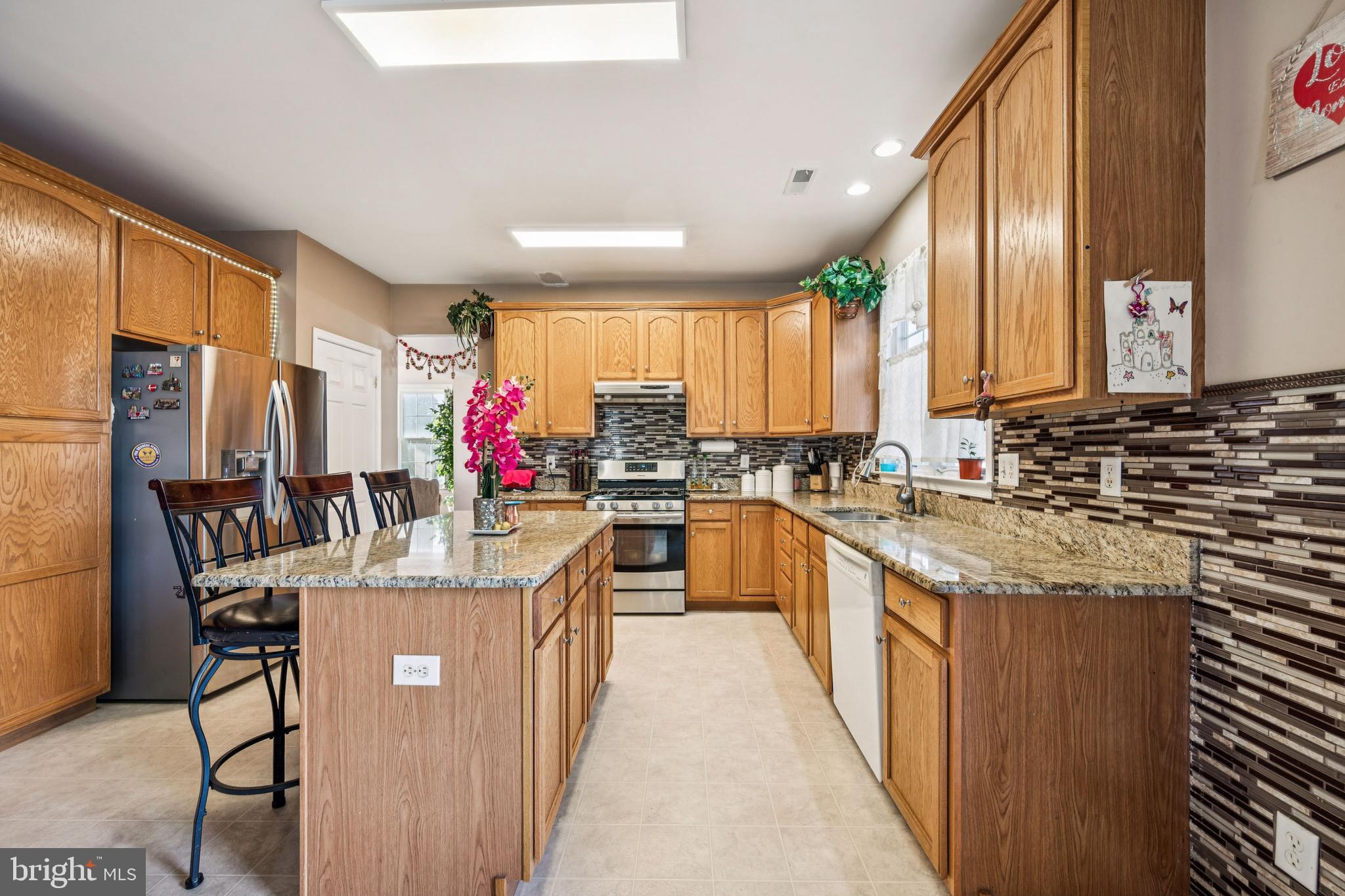 17 Jasmine Way Sewell, NJ 08080 - Photo 4 of 30 a kitchen with cabinets counter top space and stainless steel appliances