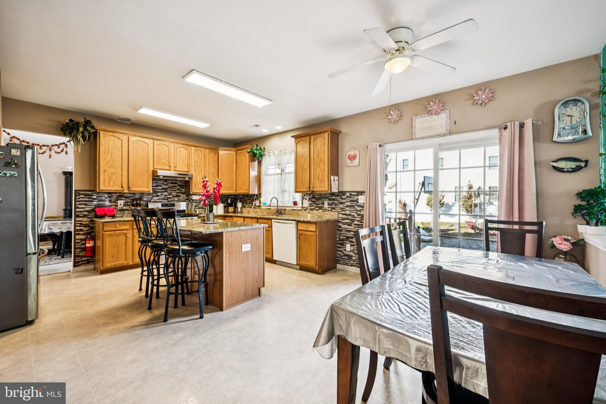 17 Jasmine Way Sewell, NJ 08080 - Photo 6 of 30 a kitchen with kitchen island granite countertop wooden floors and stainless steel appliances