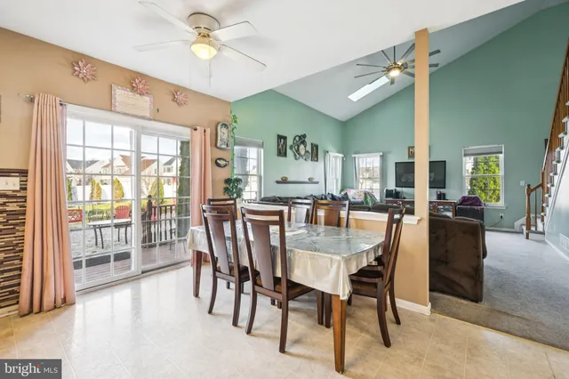 a dining room with furniture a chandelier and a painting