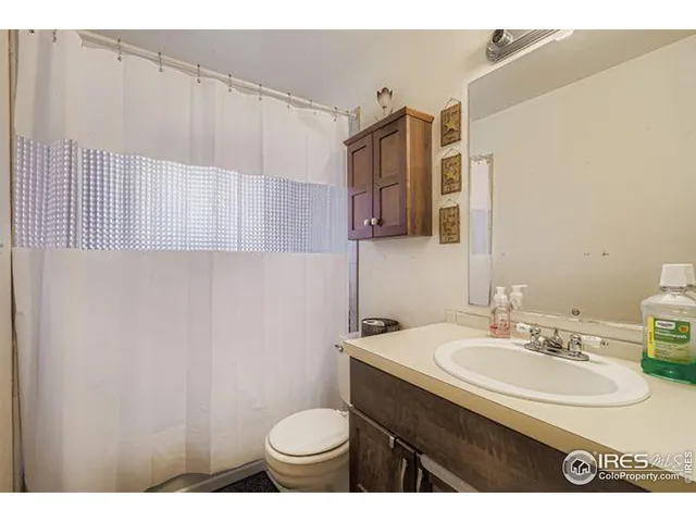 a bathroom with a sink toilet a mirror and shower