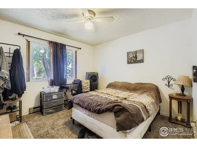 a bedroom with a bed next to a window with the outer view