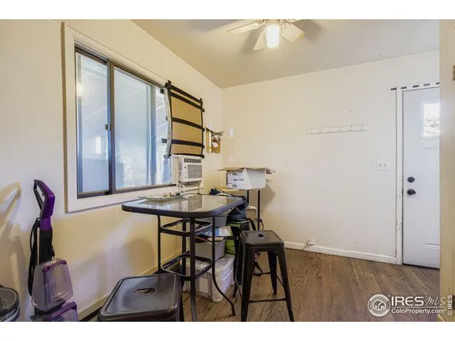 a view of a room that has a table and chairs in it