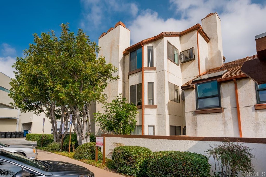 376 Center Street, Unit 348 Chula Vista, CA 91910 - Photo 1 of 27 a view of a white building among the street with palm trees
