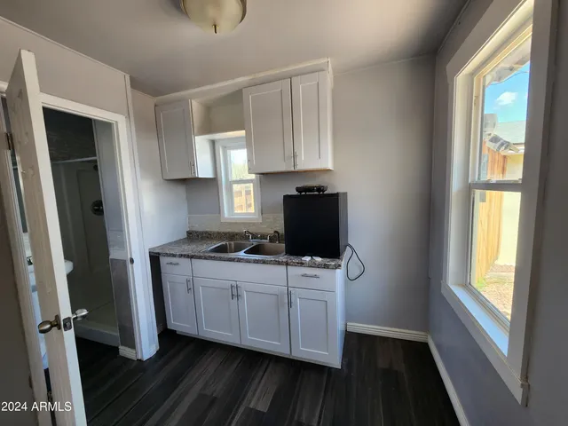 a kitchen with stainless steel appliances a stove microwave and sink