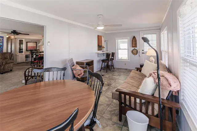 a dining room with furniture a rug and wooden floor