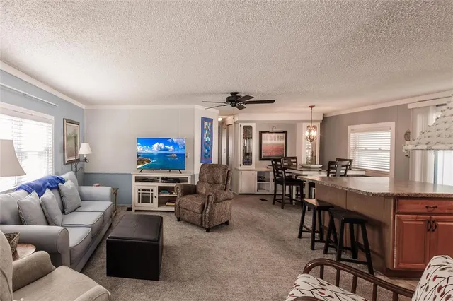 a living room with furniture a air conditioner and a window