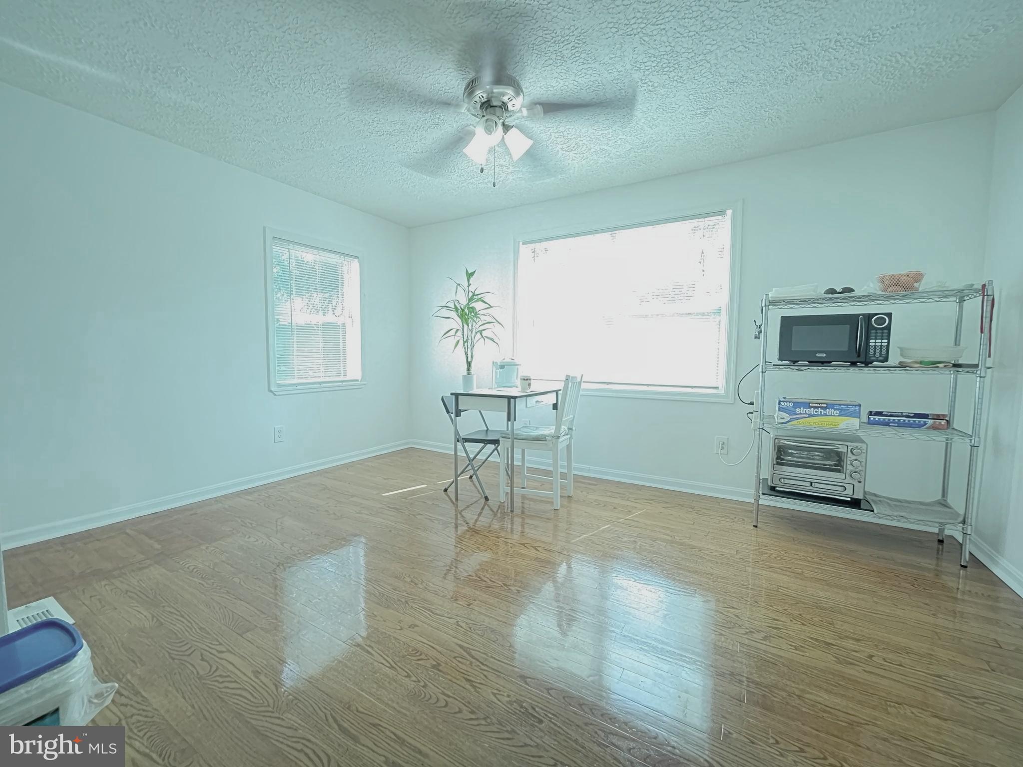 12306 Veirs Mill Road Silver Spring, MD 20906 - Photo 11 of 45 a room with furniture and a chandelier