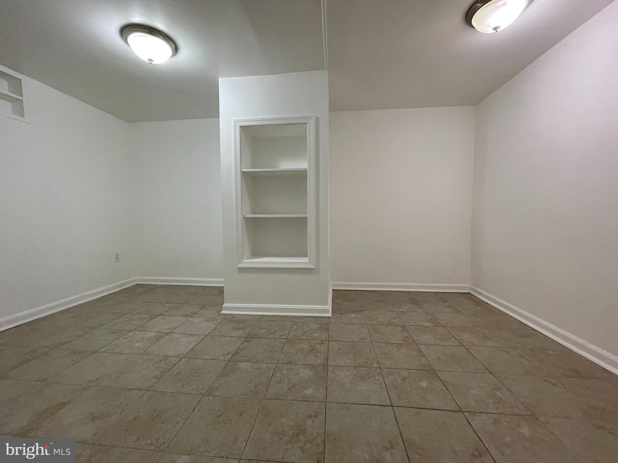 12306 Veirs Mill Road Silver Spring, MD 20906 - Photo 34 of 45 a view of an empty room with cabinet and window