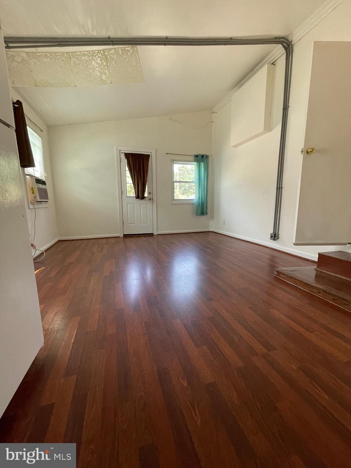 12306 Veirs Mill Road Silver Spring, MD 20906 - Photo 37 of 45 a view of an empty room with wooden floor and a window