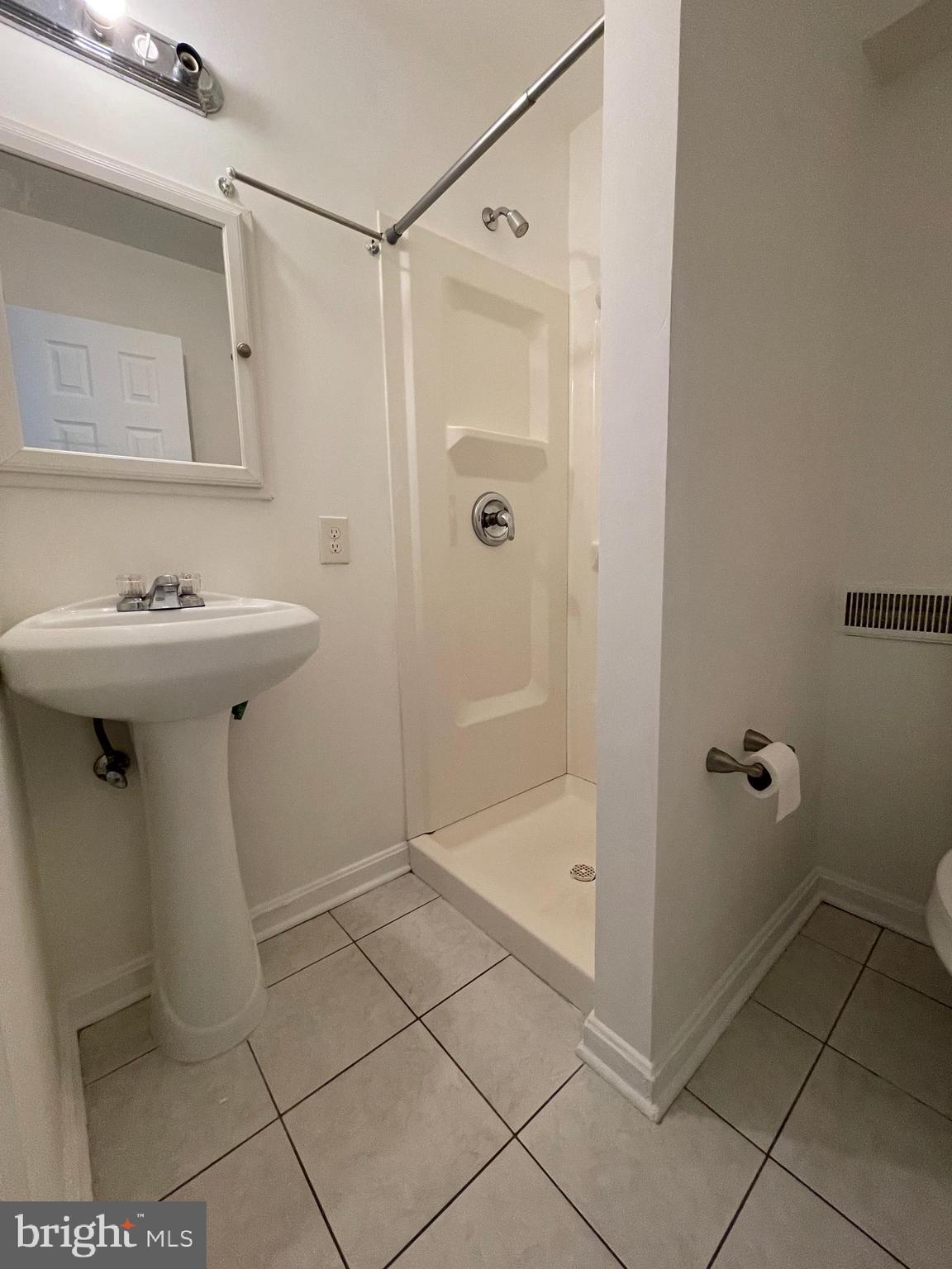 12306 Veirs Mill Road Silver Spring, MD 20906 - Photo 40 of 45 a bathroom with a sink a toilet and shower