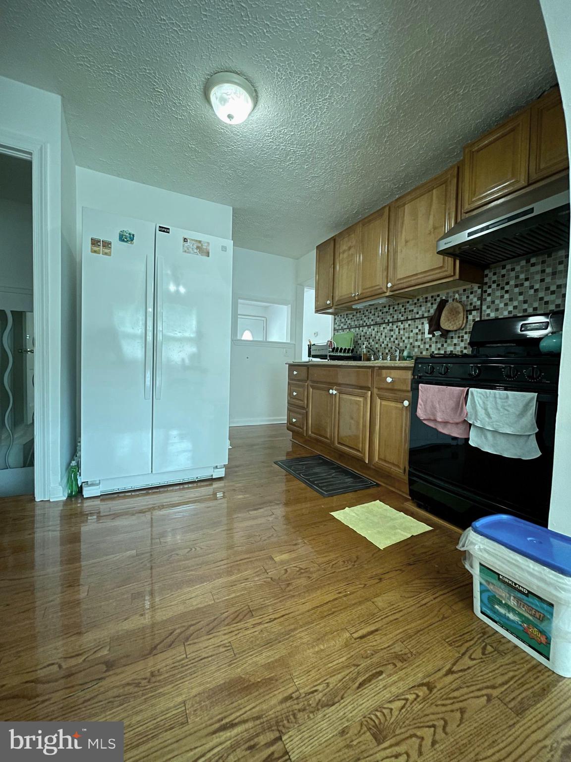 12306 Veirs Mill Road Silver Spring, MD 20906 - Photo 45 of 45 a kitchen with granite countertop a stove a sink and a refrigerator