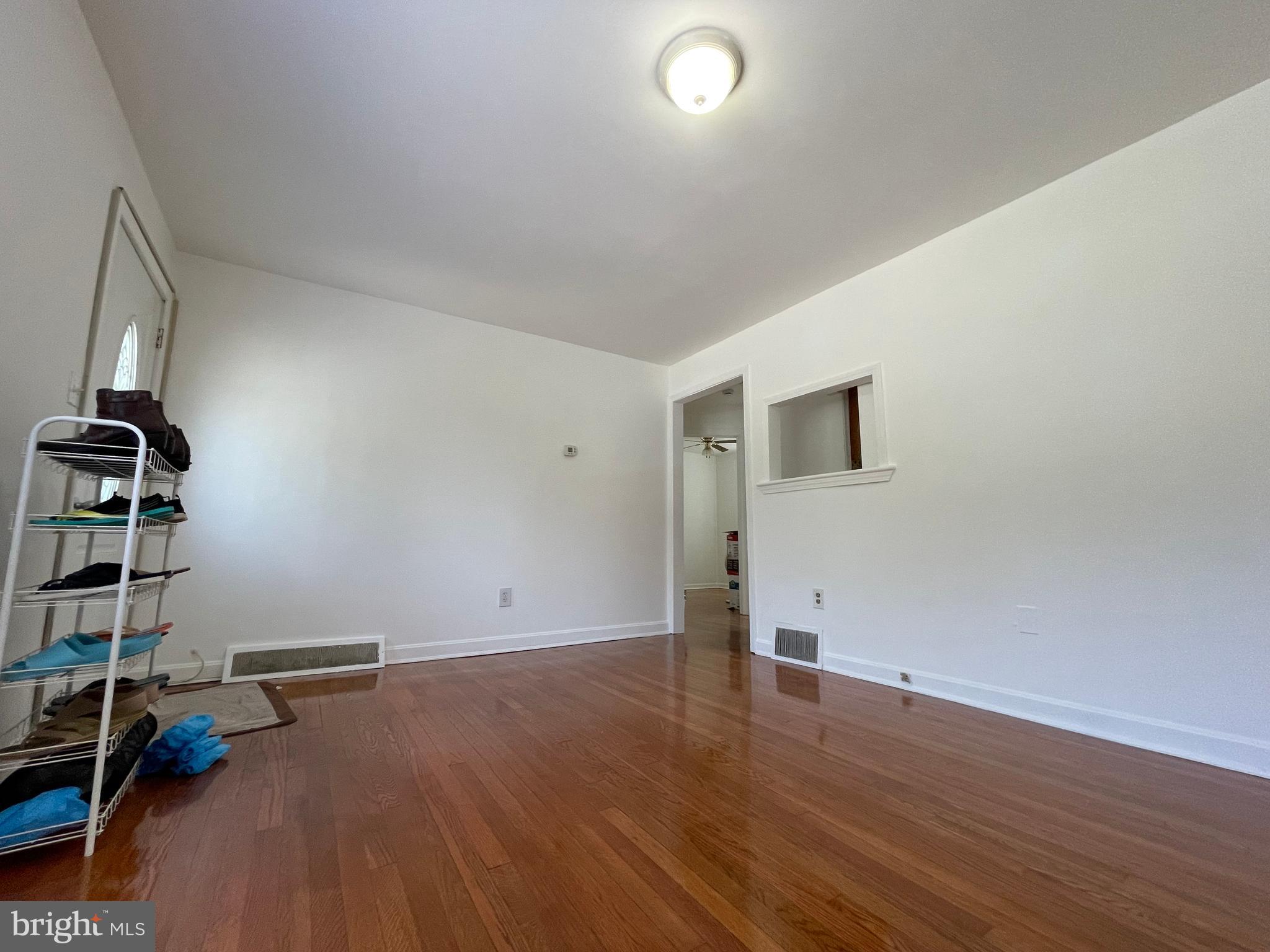 12306 Veirs Mill Road Silver Spring, MD 20906 - Photo 7 of 45 an empty room with wooden floor and windows