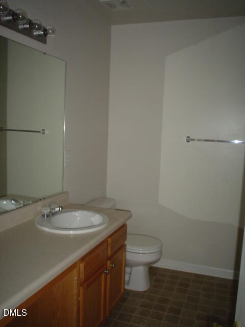 6005 Namozine Court Raleigh, NC 27610 - Photo 5 of 8 a bathroom with a sink toilet and vanity