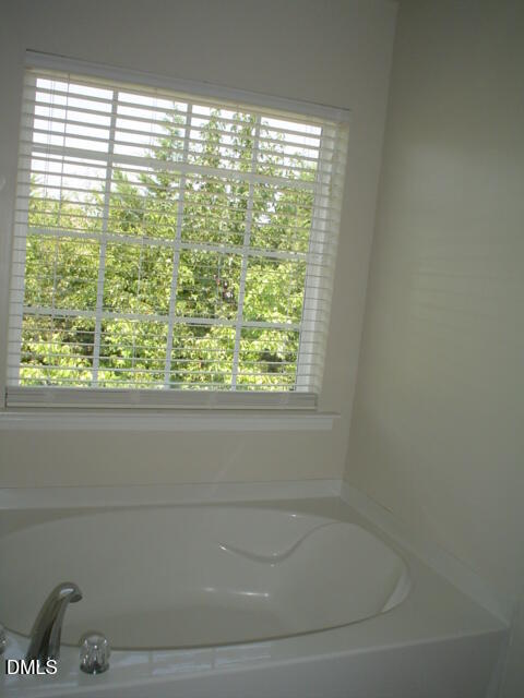 6005 Namozine Court Raleigh, NC 27610 - Photo 8 of 8 a bathroom with a window