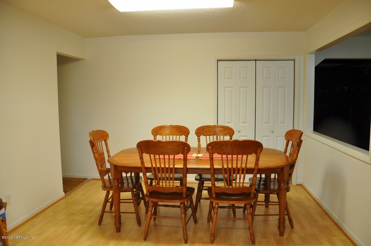 4147 Pinto Road Middleburg, FL 32068 - Photo 24 of 31 a view of a dining room with furniture and wooden floor