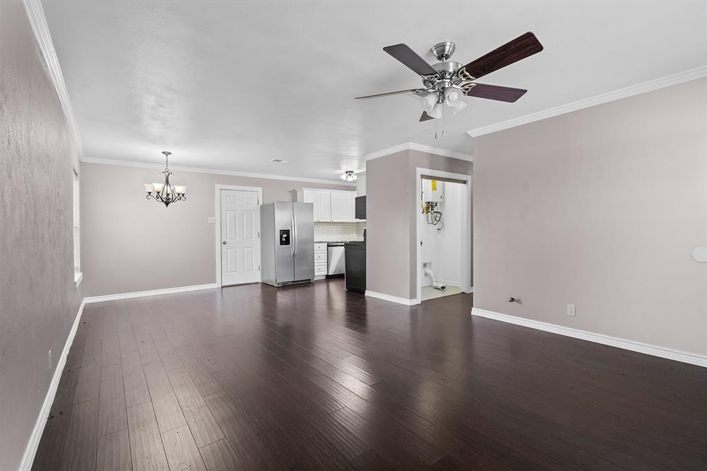 1135 Reed Circle Howe, TX 75459 - Photo 8 of 28 an empty room with wooden floor ceiling fan and windows