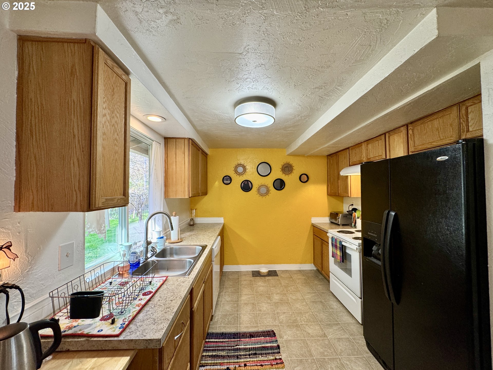 397 River Loop 2 Eugene, OR 97404 - Photo 15 of 42 a kitchen with stainless steel appliances a stove a refrigerator and a sink
