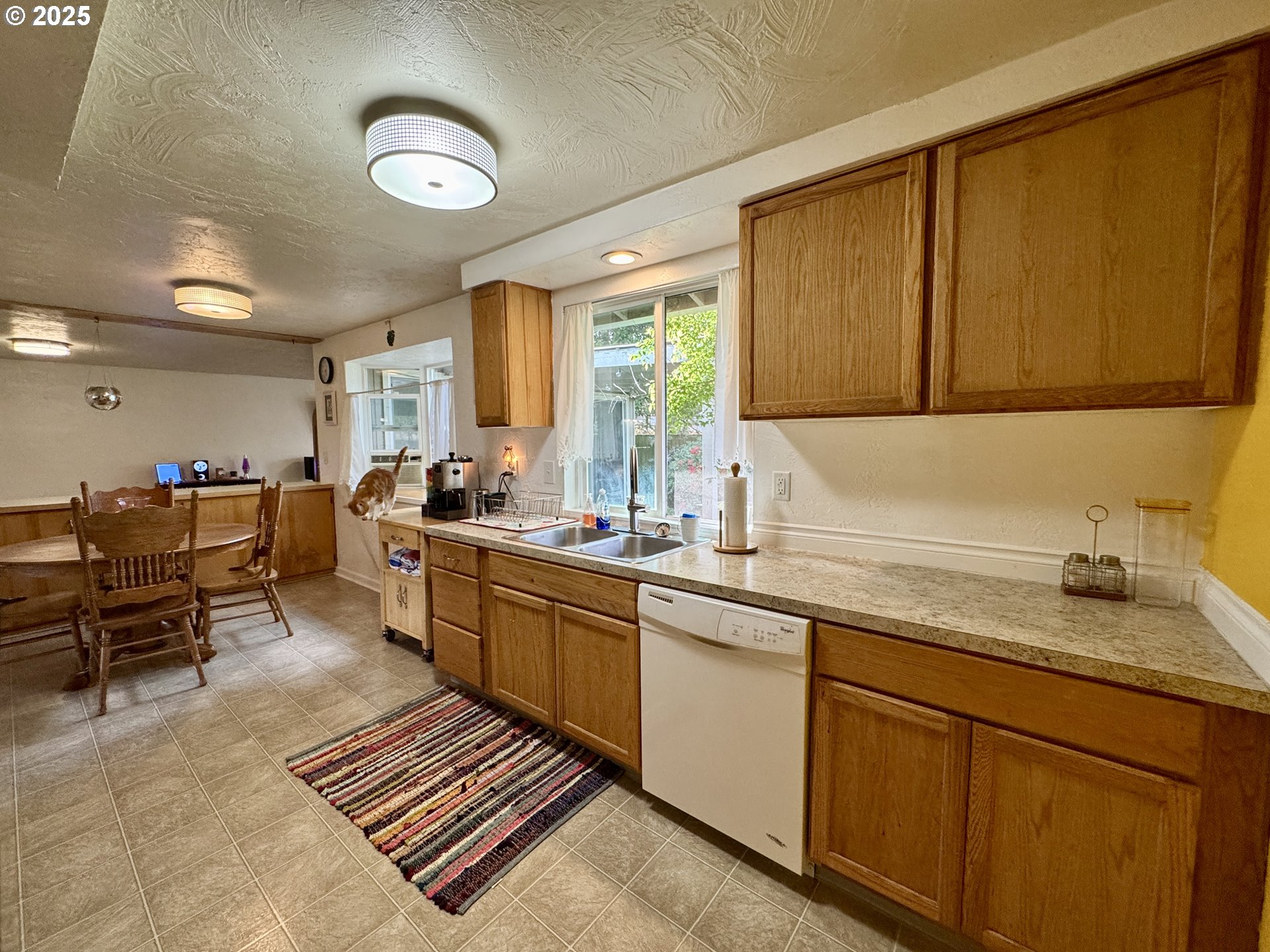 397 River Loop 2 Eugene, OR 97404 - Photo 16 of 42 a kitchen with sink cabinets and window