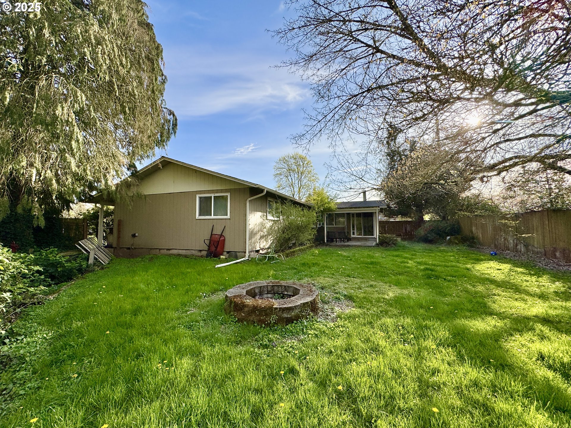 397 River Loop 2 Eugene, OR 97404 - Photo 32 of 42 a backyard of a house with plants and large tree
