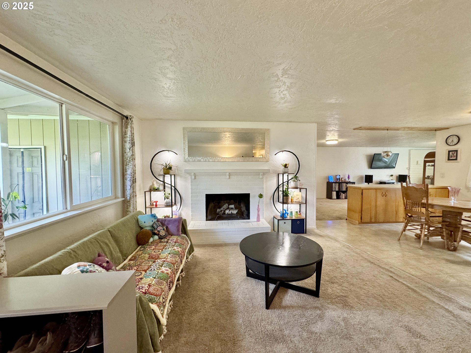 397 River Loop 2 Eugene, OR 97404 - Photo 5 of 42 a living room with furniture and a fireplace