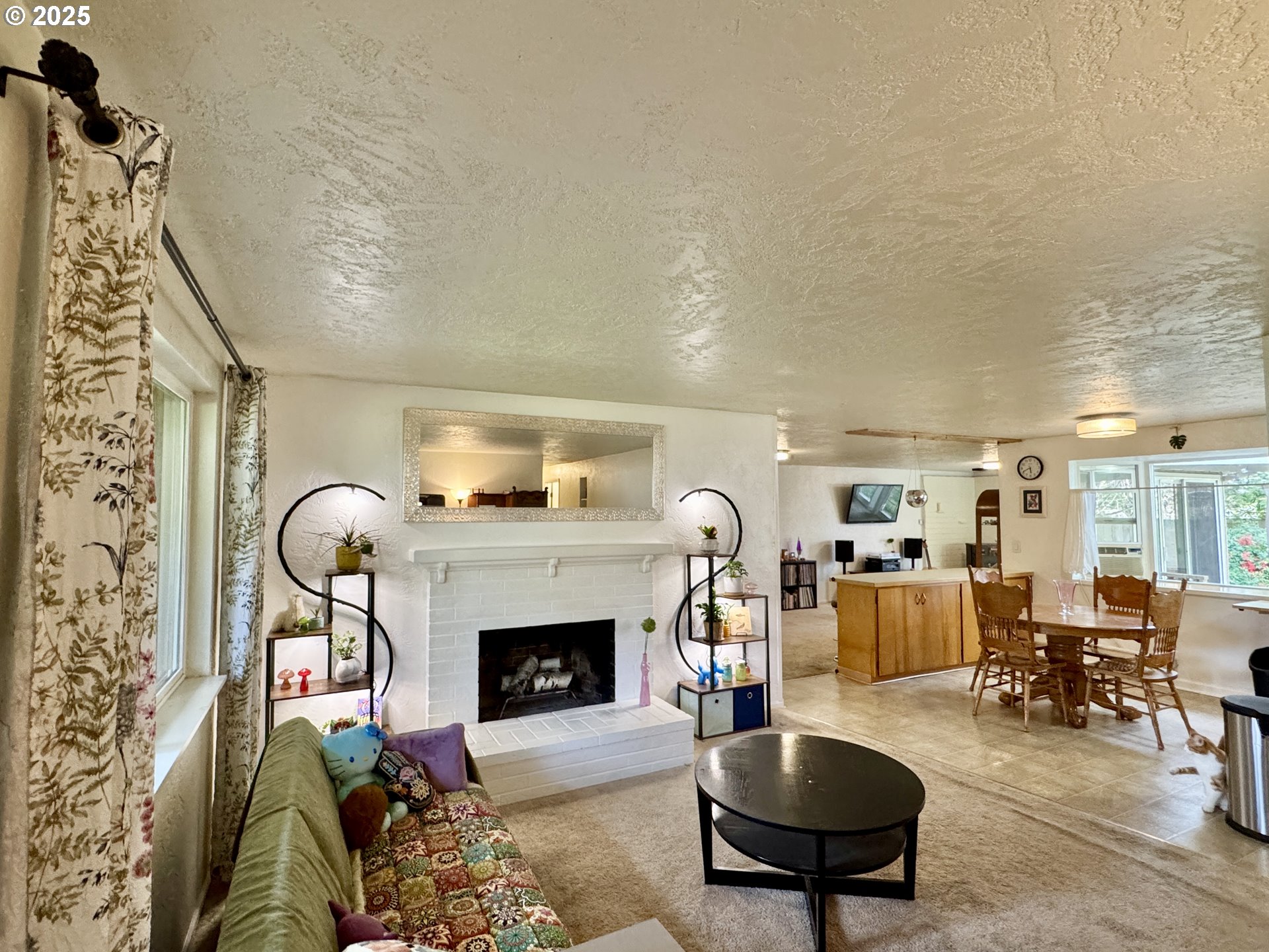 397 River Loop 2 Eugene, OR 97404 - Photo 8 of 42 a living room with furniture a rug and a fireplace