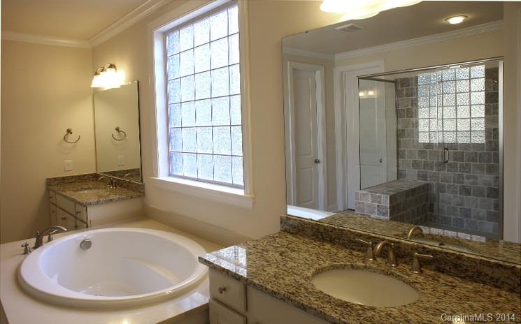 654 Chase Court, Unit 130 Fort Mill, SC 29708 - Photo 7 of 9 a bathroom with a granite countertop sink and a mirror