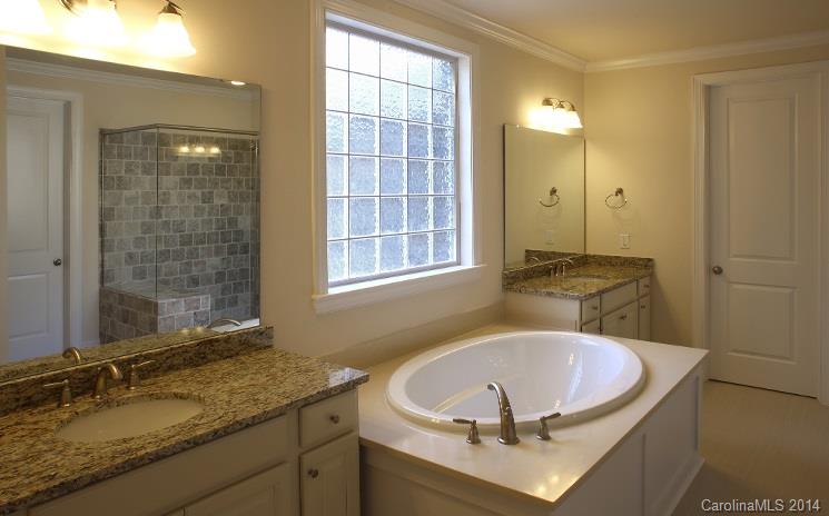 654 Chase Court, Unit 130 Fort Mill, SC 29708 - Photo 8 of 9 a bathroom with a sink and a mirror