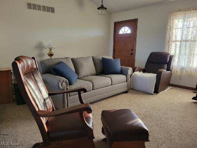 9915 Acme Road Rittman, OH 44270 - Photo 5 of 22 Carpeted living room with a healthy amount of sunlight