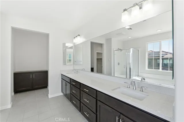 a bathroom with a sink double vanity and a mirror
