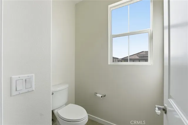 a white toilet sitting next to a bathroom sink