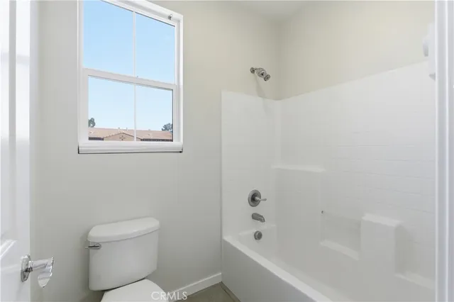 a white bath tub sitting next to a toilet