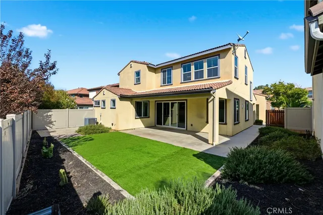 a view of house with backyard outdoor seating and hardwood