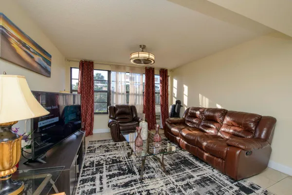 a living room with furniture ceiling fan and a rug