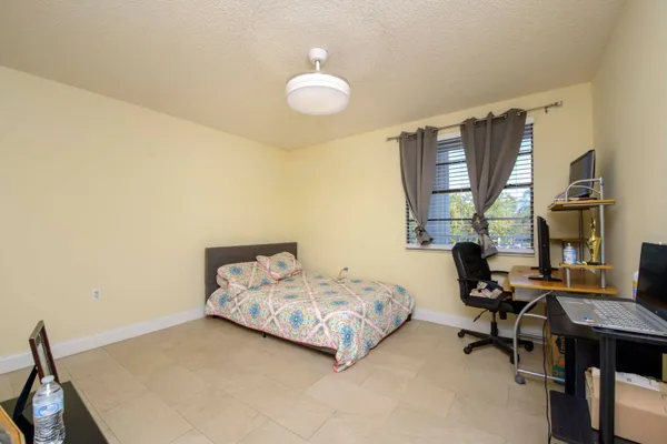 a bedroom with bed and window