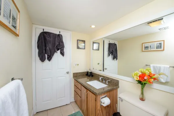 a bathroom with a sink mirror and vanity