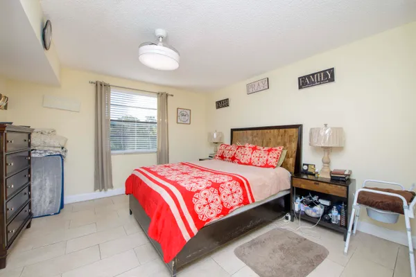 a bedroom with bed and a window