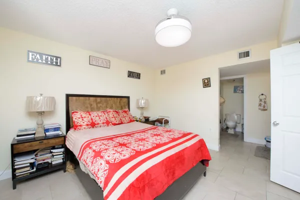 a bedroom with a bed and a lamp