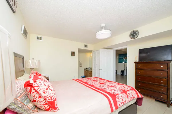 a bedroom with a bed and a dresser