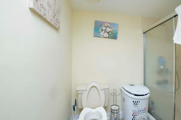 a bathroom with a toilet a sink and a shower