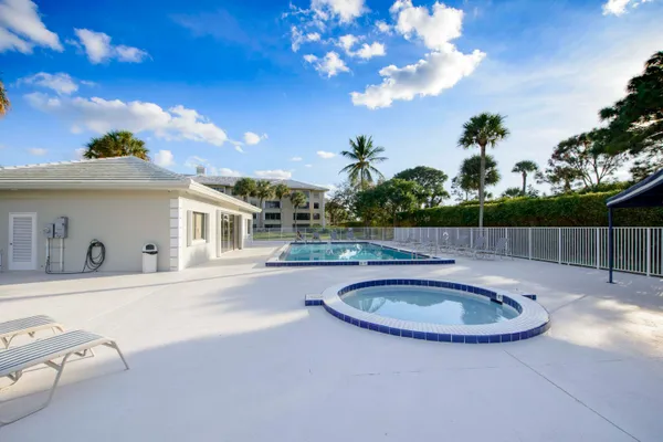 a view of a swimming pool with a yard
