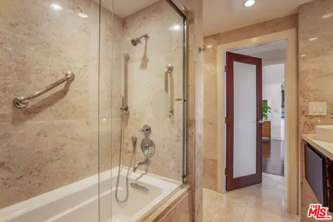 a bathroom with a granite countertop shower mirror and a sink