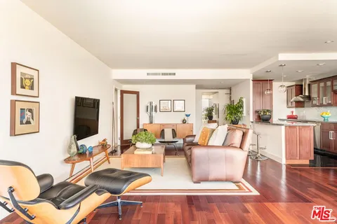 a living room with fireplace furniture and a flat screen tv