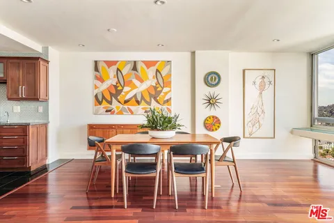 a dining room with furniture and wooden floor