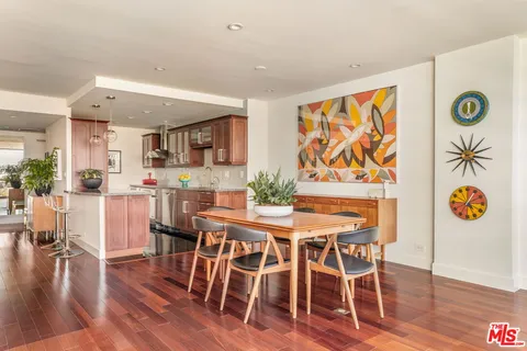 a view of a dining room with furniture and wooden floor