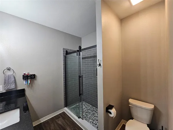 a bathroom with a toilet and shower